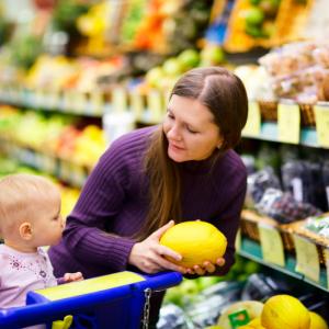 Mother and baby looking at fruit